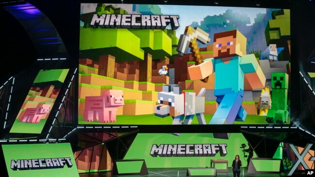 Lydia Winters shows off Microsoft's "Minecraft" built specifically for HoloLens at the Xbox E3 2015 briefing before Electronic Entertainment Expo, June 15, 2015, in Los Angeles. (AP Photo/Damian Dovarganes, File) 