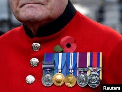 A veteran visits the Field of Remembrance at Westminster Abbey in London, Nov. 8, 2018.