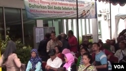 Masyarakat mengantre di kantor BPJS Kesehatan Kota Bandung untuk mendaftar sebagai anggota asuransi tersebut. (VOA/R. Teja Wulan)