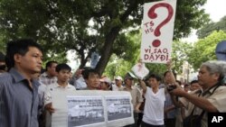 Protesters hold anti-China placards while marching near the Chinese embassy in Hanoi July 10, 2011