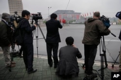 Foreign journalists are seen filming the April 25 House of Culture, the venue for the 7th Congress of the Workers' Party of Korea, on May 6, 2016, in Pyongyang, North Korea.