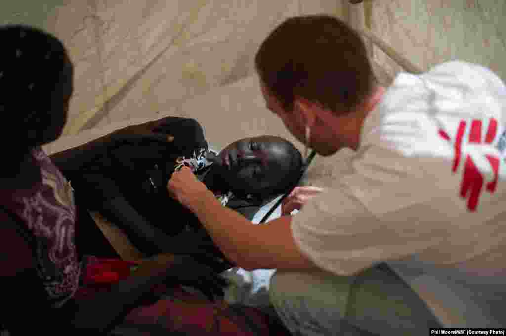 A Médecins Sans Frontières (MSF) doctor treats a girl who suffered an electric shock, at the MSF clinic set up at the camp for displaced people in the grounds of the United Nations Mission to South Sudan (UNMISS) base in Juba, South Sudan, on January 12,
