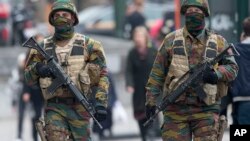 FILE - Soldiers, on high terror alert, patrol in Brussels, Belgium, March 24, 2016. Experts fear that, if driven out of their strongholds in the Middle East, IS militants will move on and stage attacks in other countries.