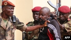 FILE - Troops arrest CAR MP Alfred Yekatom after he fired the gun at the parliament in Bangui, Oct. 29, 2018. Yekatom was extradited Nov. 17, 2018, to The Hague, The Netherlands, after an arrest warrant was issued by the International Criminal Court. 