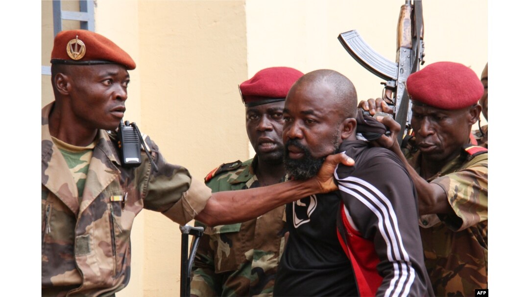 FILE - Members of the armed forces arrest Central African Republic MP Alfred Yekatom after he fired a gun at the parliament in Bangui, Oct. 29, 2018.