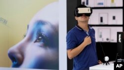 China South Korea Samsung Battery Fires: FILE - In this Wednesday, Sept. 7, 2016, file photo, a man tries out the Samsung VR using their latest Galaxy Note 7 smartphone at a roadshow outside a shopping mall in Beijing.