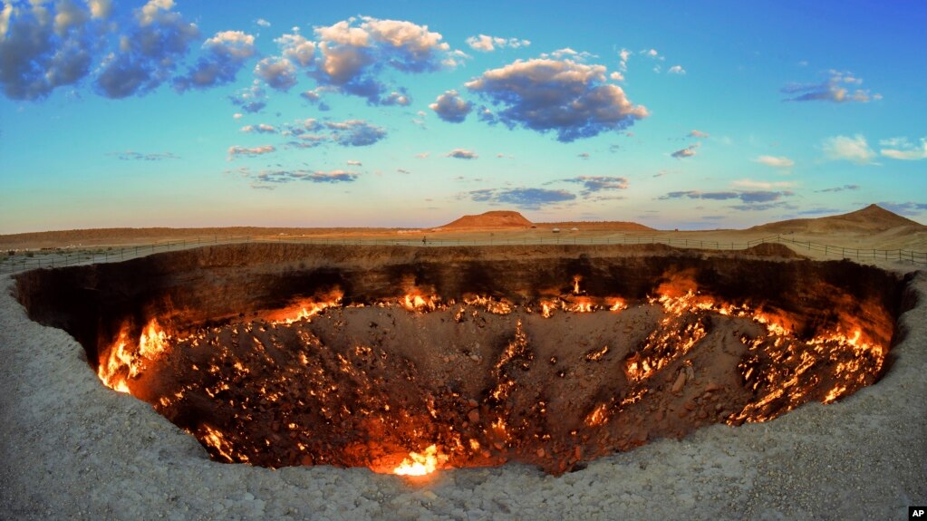 The crater fire named "Gates of Hell" is seen near Darvaza, Turkmenistan, Saturday, July 11, 2020. The president of Turkmenistan is calling for an end to one of the country's blazing desert natural gas crater. (AP Photo/Alexander Vershinin)