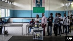 Des électeurs attendent en ligne devant un bureau de vote à N'djili, Kinshasa, 30 décembre 2018.