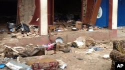 In this photo taken on a mobile phone, debris is strewn after a bomb exploded at a mosque in Jos, Nigeria, July 6, 2015.