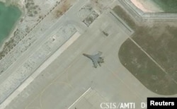 Satellite imagery shows the deployment of several new weapons systems, including a J-11 combat aircraft, at China’s base on Woody Island in the Paracels, South China Sea, May 12, 2018.