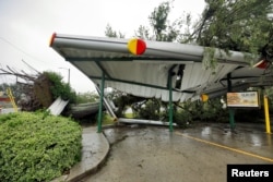 A fallen tree lies atop the crushed roof of a fast food restaurant after the arrival of Hurricane Florence in Wilmington, North Carolina, U.S., Sept. 14, 2018.