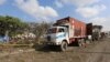 Trailers are parked outside a police cordon after a suicide car bomb went off at the entrance of Somalia's biggest port in its capital, Mogadishu, Dec. 11, 2016.
