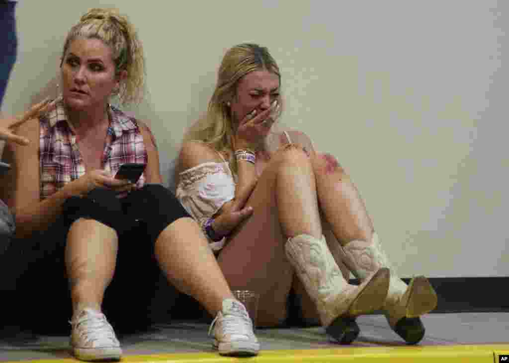 A woman cries while hiding inside the Sands Corporation plane hangar after a mass shooting in which dozens were killed at the Route 91 Harvest country festival, Oct. 1, 2017, in Las Vegas, Nevada.