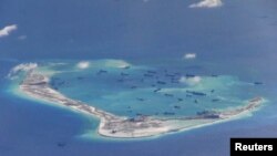 Chinese dredging vessels are seen in the waters around Mischief Reef in the disputed Spratly Islands in the South China Sea. This is a still image from video taken by a P-8A Poseidon surveillance aircraft provided by the United States Navy, May 21, 2015. (REUTERS/U.S. Navy/Handout via Reuters)