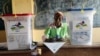 FILE - A election official writes as people cast their ballots during elections in Bangui, Central African Republic, Dec. 30, 2015. 