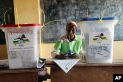 A election official writes as people cast their ballots during elections in Bangui, Central African Republic, Dec. 30, 2015.