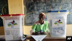 FILE - A election official writes as people cast their ballots during elections in Bangui, Central African Republic, Dec. 30, 2015. 