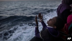 A child from Eritrea sings to celebrate his arrival to Europe aboard the Spanish NGO Proactiva Open Arms rescue vessel near Sicily, Italy, Jan. 19, 2018.