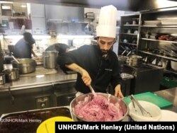 Chef Nadeem Khadem Al Jamie, a Syrian refugee, works in the kitchen of the Hotel d'Angleterre for the Refugee Food Festival, Oct. 11, 2017.