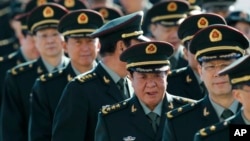 Chinese military officers are shown the way as they arrive outside the Great Hall of the People in Beijing, China, March 4, 2013.