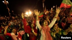 Supporters of Pakistani cricketer-turned-politician, Imran Khan, cheer while listening to him speak in Islamabad August 20, 2014.