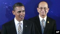 U.S. President Barack Obama, left, stands with Myanmar President Thein Sein during a group photo session at the East Asia Summit in Nusa Dua, on the island of Bali, Indonesia, Saturday, Nov. 19, 2011. (AP Photo/Charles Dharapak)