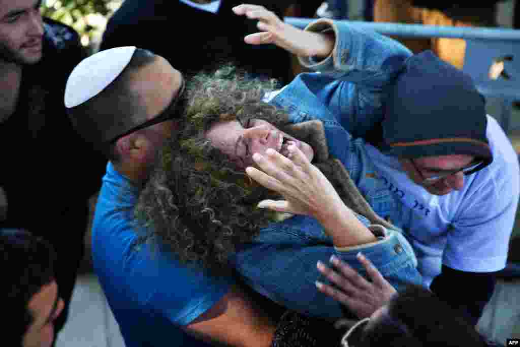 The mother of 18-year-old Israeli soldier Ziv Mizrahi, killed by a Palestinian knife assault at a gas station on route 443 on the edge of the West Bank, mourns during his funeral at the Mount Herzl military cemetery in Jerusalem.