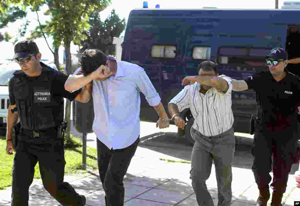 Turkish military personnel, who were aboard a Blackhawk military helicopter, are transferred to a prosecutor&#39;s office in the city of Alexandroupolis, northern Greece, July 17, 2016.&nbsp;A Blackhawk military helicopter with seven Turkish military personnel and one civilian landed in the Greek city, where theyrequested asylum.&nbsp;