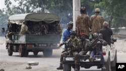 Soldiers loyal to Alassane Ouattara head off for battle as they deploy from a checkpoint at one of the principal entrances to Abidjan, Ivory Coast, Wednesday, April 6, 2011.