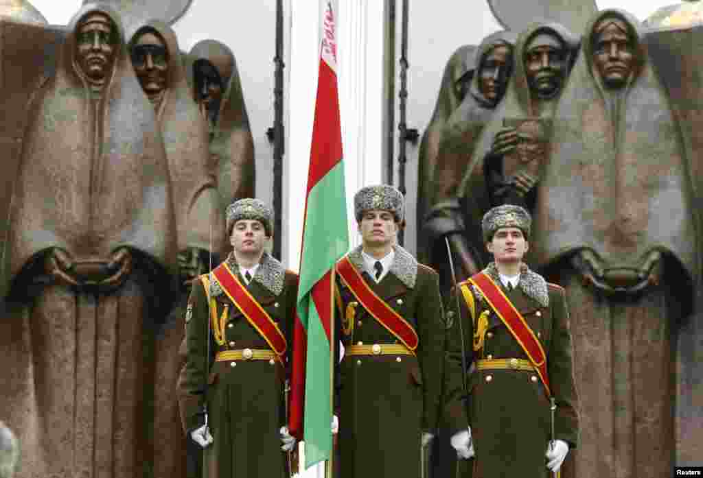 Honor guards stand near a monument in Minsk, Belarus, commemorating the Soviet victims of the war in Afghanistan, along with many former Soviet states, marked the 25th anniversary of the Soviet troops&#39; withdrawal from Afghanistan where they fought for more than nine years.