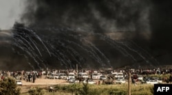  FILE - Israeli forces fire tearing gas demonstrators east of Gaza City along the border" In the rare cases where an investigation has led to an indictment, the sentence has been extremely lenient in light of the gravity of the crime committed. between the Gaza Strip and Israel during confrontations with Palestinian protesters, June 29, 2018. 