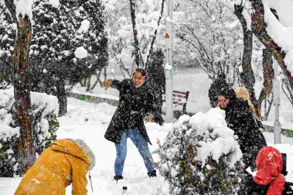 Children take part in a snow fight at a park in the Iranian capital Tehran.