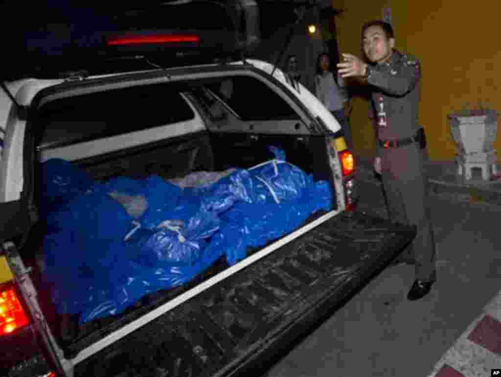 The bodies of slain British tourists, wrapped in plastic sheets, Hannah Witheridge and David Miller, are delivered at a forensic police facility in Bangkok, Thailand, Tuesday , Sept. 16, 2014. Police on the scenic resort island of Koh Tao in southern Thailand conducted a sweep of hotels and workers' residences Tuesday searching for clues into the slayings of the two British tourists whose nearly naked, battered bodies were found on a beach a day earlier.(AP Photo/Sakchai Lalit)