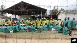FILE - Female prisoners wait for their turn to walk out of prison following their release at Chikurubi Maximum prison on the outskirts of Harare, Feb. 17, 2014.
