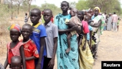 FILE - Residents displaced due to the recent fighting between government and rebel forces in the Upper Nile capital Malakal wait at a World Food Program (WFP) outpost.