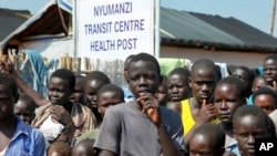 FILE - Refugees gather at a transit center for South Sudanese refugees in the remote northwestern district of Adjumani, near the border with South Sudan, in Uganda, Aug. 29, 2016. 