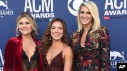 Hannah Mulholland, from left, Naomi Cooke and Jennifer Wayne, of Runaway June, arrive at the 54th annual Academy of Country Music Awards at the MGM Grand Garden Arena, April 7, 2019, in Las Vegas.