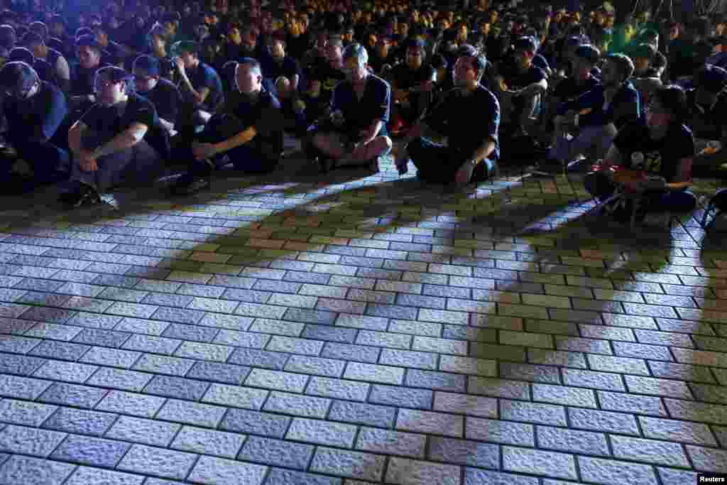 Shadows cast on university students and staff as they wear black to attend a rally at the University of Hong Kong in Hong Kong, China. More than a thousand students and staff attended the rally, the second demonstration in a week to protest against what they say is interference by Beijing in academic freedom.