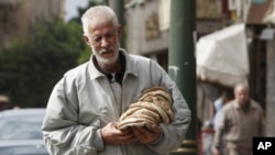 A man carries bread bought from a bakery in Cairo on February 6, 2011.