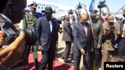 Sudan’s President Omar al-Bashir, right, welcomes South Sudan's President Salva Kiir at Khartoum airport, Sudan, Nov. 1, 2017.