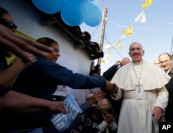 Pope Francis is greeted by the faithful during his visit to the Banado Norte neighborhood in Asuncion, Paraguay, July 12, 2015.