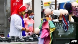  People shop for face-coverings in Los Angeles, California on July 2, 2020, where enforcement measures may be issued regarding the wearing of facemasks as coronavirus cases see a resurgence after over three months of precautionary measures.
