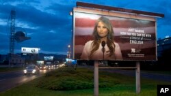 Cars drive past a billboard depicting U.S. first lady Melania Trump and advertising a language school, in Zagreb, Croatia, Sept. 15, 2017.