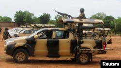 FILE - A Nigerian soldier is seen operating a weapon atop a truck.