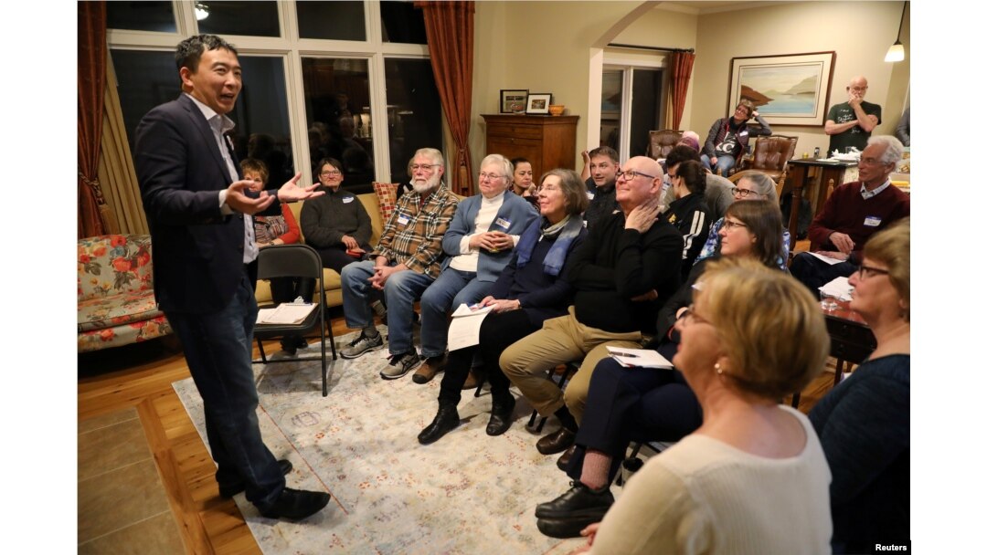 FILE - U.S. 2020 Democratic presidential candidate Andrew Yang speaks at Potluck Insurgency, a local Democratic activist event, at the home of one of its members in Iowa City, Iowa, March 10, 2019.