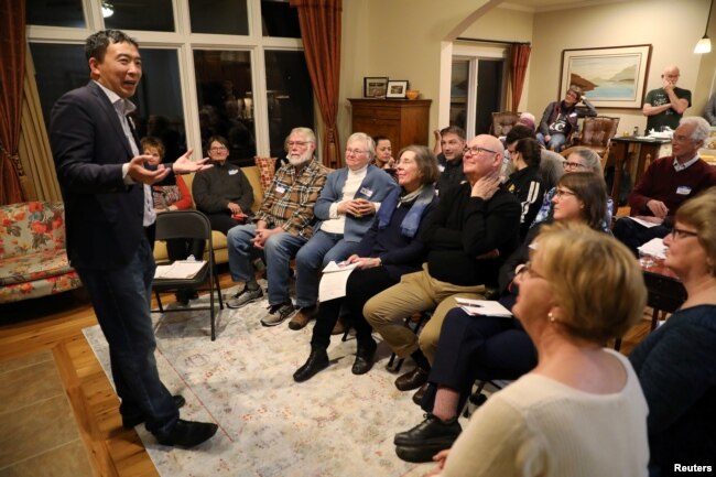 FILE - U.S. 2020 Democratic presidential candidate Andrew Yang speaks at Potluck Insurgency, a local Democratic activist event, at the home of one of its members in Iowa City, Iowa, March 10, 2019.