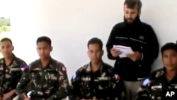 In this image taken from video obtained from the Ugarit News, which has been authenticated based on its contents and other AP reporting, four abducted Filipino UN peacekeepers are seen in Daraa, Syria, May 9, 2013.