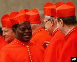 FILE - Cardinal Laurent Monsengwo Pasinya of the Democratic Republic of Congo, left, stands by other cardinals at the St. Peter's Basilica, at the Vatican, Nov. 20, 2010.