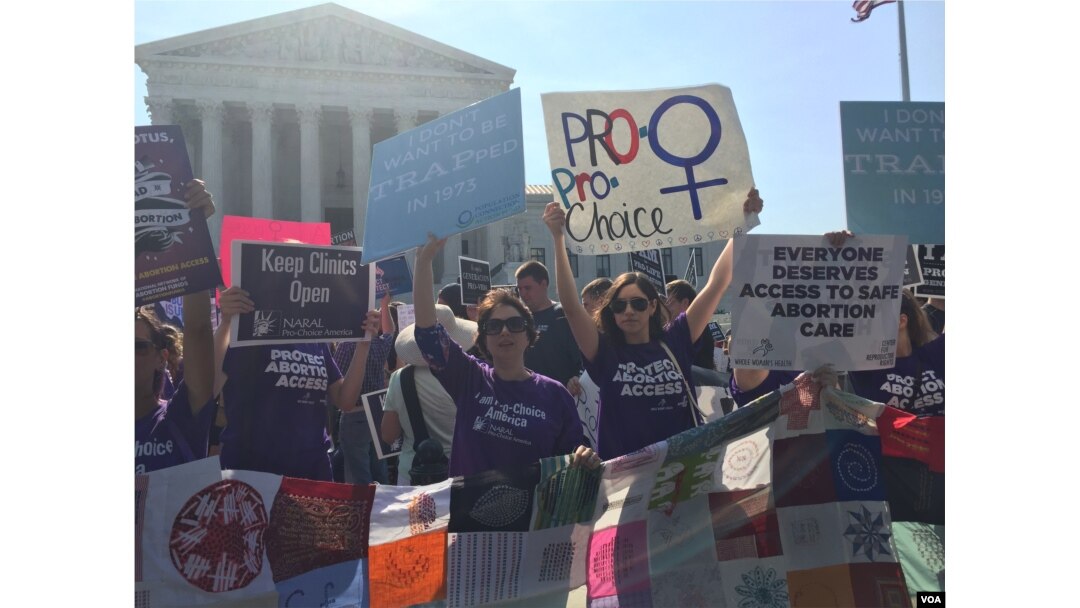 Pro-choice demonstrators wave signs and make their voices heard after the Supreme Court upheld abortion rights in a 5-3 decision, in front of the Supreme Court building in Washington, June 27, 2016. (J. Oni / VOA News)