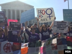 Pro-choice demonstrators wave signs and make their voices heard after the Supreme Court upheld abortion rights in a 5-3 decision, in front of the Supreme Court building in Washington, June 27, 2016. (J. Oni / VOA News)